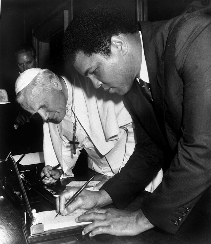 Pope John Paul II Looks On As Muhammad Ali, Former Heavyweight Boxing Champion, Signs His Autograph In Vatican City, June 6, 1982