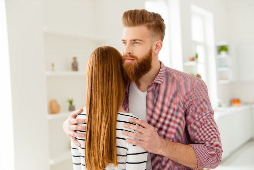 Calm down quarrel stress depression concept. Portrait of happy cunning curious guy thinking about something else and hugging her girlfriend wearing red checkered casual shirt striped sweater