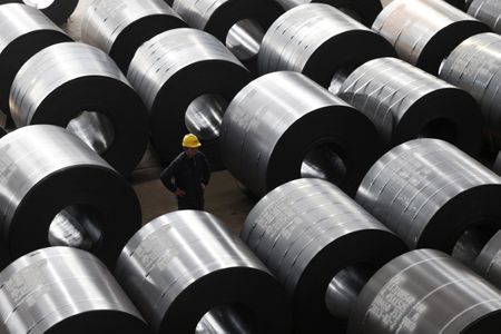 An employee works at a steel factory that exports to Europe and America in Jiaxing, Zhejiang province, February 28, 2013. Growth in Chinese factories cooled in February to a five-month low after domestic and foreign demand slackened, an official government survey showed on Friday, missing market forecasts and underscoring China's patchy economic recovery. Picture taken February 28, 2013. REUTERS/William Hong (CHINA - Tags: BUSINESS INDUSTRIAL)