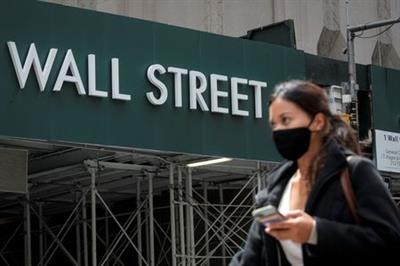 A Wall St. sign is seen near the New York Stock Exchange (NYSE) in New York City, U.S., May 4, 2021. REUTERS/Brendan McDermid 