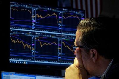 A specialist trader works inside a booth on the floor of the New York Stock Exchange (NYSE) in New York City, U.S., October 6, 2021. REUTERS/Brendan McDermid