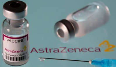 Vial labelled "AstraZeneca coronavirus disease (COVID-19) vaccine" placed on displayed AstraZeneca logo is seen in this illustration picture taken March 24, 2021. REUTERS/Dado Ruvic/Illustration