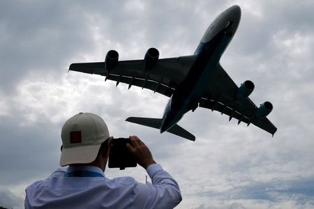A visitor takes a picture of an Airbus A380 as it lands after an air display at the 53rd International Paris Air Show at Le Bourget Airport near Paris, France June 23, 2019. REUTERS/Pascal Rossignol