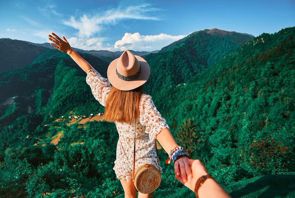 follow-me-concept-and-traveling-together-girl-traveler-wearing-hat-round-straw-bag-and-short-jumpsuit-holds-the-boyfriend-s-hand-and-leading-to-green-big-mountains-vacation_122732-4280.jpeg.jpg