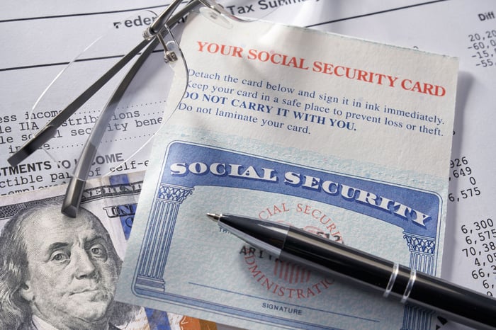 A Social Security card, a pen, and Ben Franklin.