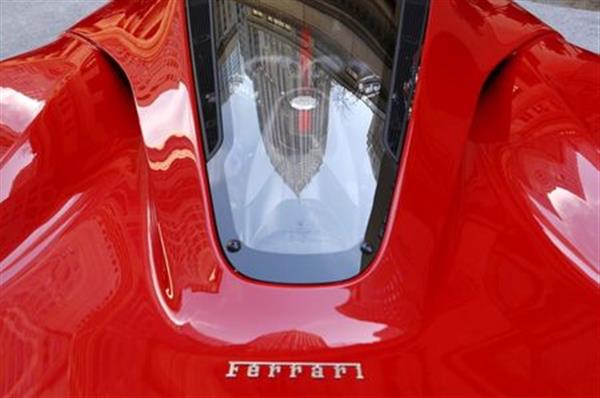 A Ferrari sports car sits outside the New York Stock Exchange October 21, 2015. REUTERS/Lucas Jackson/File Photo 