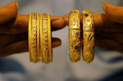 A man checks gold bangles sets at a shop selling bridal jewellery, as the coronavirus disease (COVID-19) outbreak continues, in Peshawar, Pakistan August 6, 2020. REUTERS/Fayaz Aziz