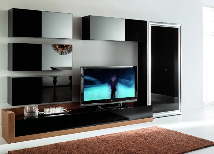 Модульная стенка в зоне для просмотра телевизора в современном стиле позволит за считанные секунды изменить интерьер во всём помещении гостиной.