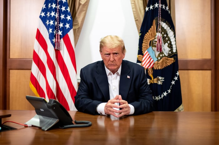 Former President Donald Trump on a conference call while seated at a desk.