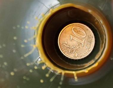 A view shows a 10 Euro cent coin is seen inside a bulb with crude oil at a laboratory in the Yarakta Oil Field, owned by Irkutsk Oil Company (INK), in Irkutsk Region, Russia in this picture illustration taken March 12, 2019. Picture taken March 12, 2019. REUTERS/Vasily Fedosenko/Illustration 