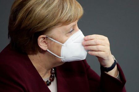 German Chancellor Angela Merkel wears a protective face mask after delivering a speech on the government's response to the coronavirus disease (COVID-19) pandemic in the country's parliament, the Bundestag, in Berlin, Germany, November 26, 2020. REUTERS/Hannibal Hanschke