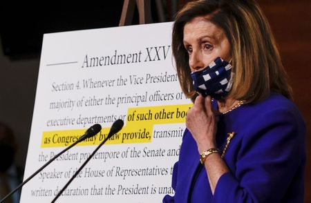 U.S. House Speaker Nancy Pelosi speaks next to a 25th Amendment display as she announces plans for Congress to create a "Commission on Presidential Capacity to Discharge the Powers and Duties of Office Act," after U.S. President Donald Trump came down with coronavirus disease (COVID-19), during a Capitol Hill news conference in Washington, U.S., October 9, 2020. REUTERS/Carlos Barria