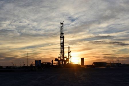 Drilling rigs operate at sunset in Midland, Texas, U.S., February 13, 2019. Picture taken February 13, 2019. REUTERS/Nick Oxford