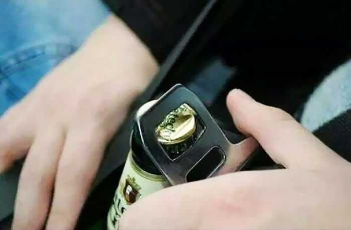 Use The Metal Part Of Your Seat Belt To Open Beers While Driving