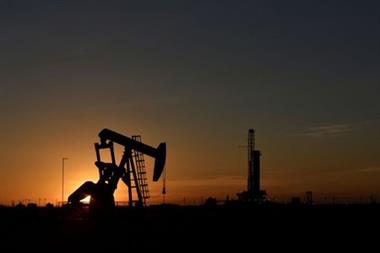 A pump jack operates in front of a drilling rig at sunset in an oil field in Midland, Texas U.S. August 22, 2018. Picture taken August 22, 2018. REUTERS/Nick Oxford 