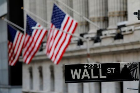 American flags hang from the facade of the New York Stock Exchange (NYSE) building after the start of Thursday's trading session in Manhattan in New York City, New York, U.S., January 28, 2021. REUTERS/Mike Segar