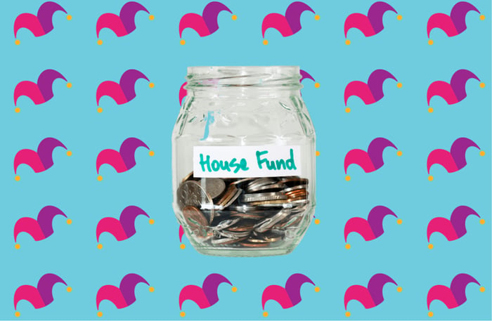 A glass jar that reads House Fund half filled with coins